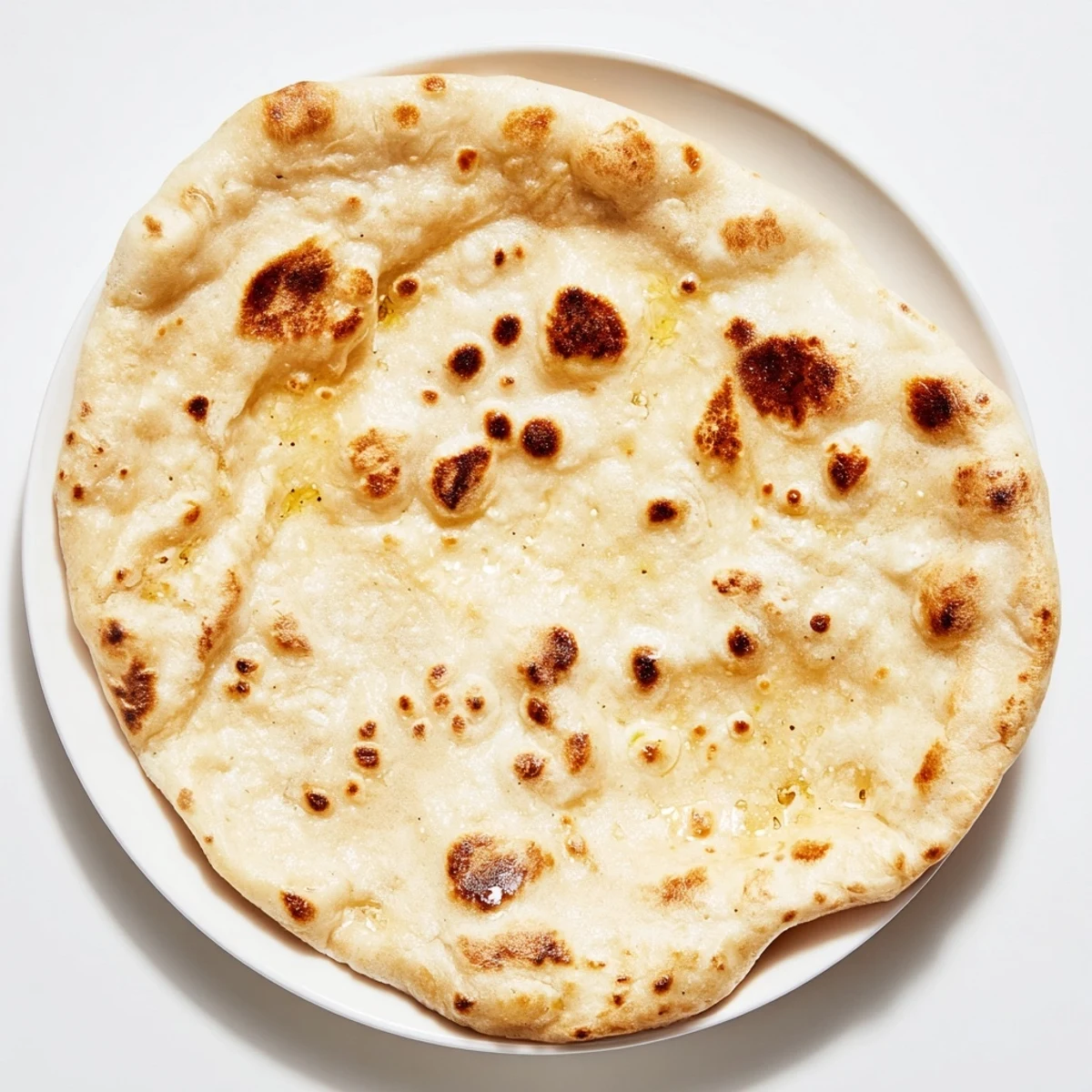 Homemade Three-Ingredient Easy Flatbreads, slightly puffed and speckled with brown from the hot skillet.