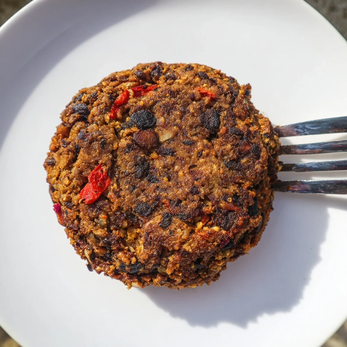 Delicious, spiced black bean burgers sizzling in a pan, promising a flavorful, vegetarian meal.