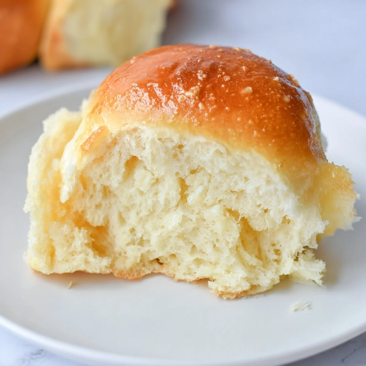 Freshly baked golden dinner rolls are pictured, perfect for sharing and a welcome addition to any table.