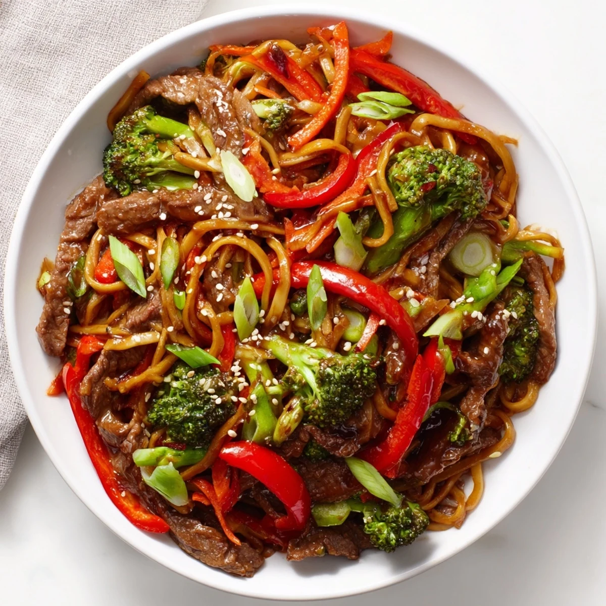 A close-up of Easy Beef Stir-Fry with Lo Mein Noodles, featuring glistening noodles and savory beef.
