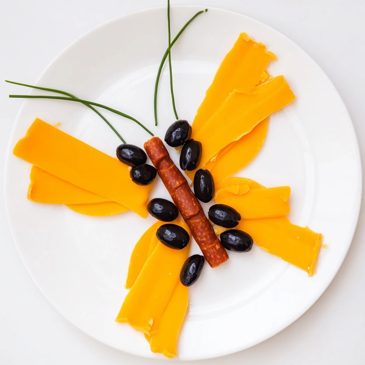 Vibrant Cheddar cheese wings and salami body make this playful Butterfly Migration appetizer a party favorite.