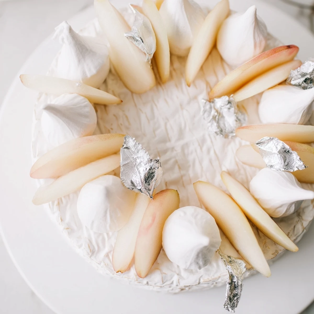 Enjoy the visually stunning The Pearly Gates, boasting peaches, brie, and light, airy meringue kisses.