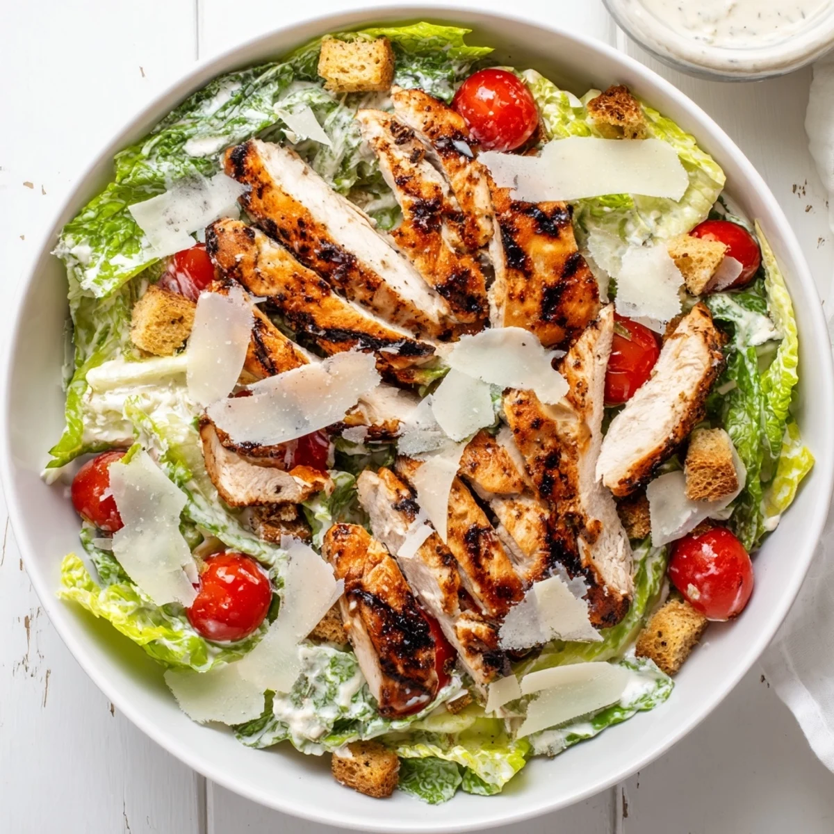 Grilled chicken strips, crisp romaine, and creamy Greek yogurt dressing make this Yogurt Caesar Grilled Chicken Salad a refreshing meal.