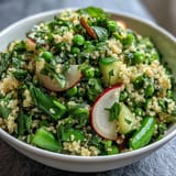Fresh spring pea and mint couscous salad with vibrant green peas, fluffy couscous, and fragrant mint, served chilled for a refreshing side dish.  
