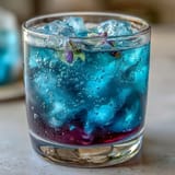 1. Vibrant butterfly pea flower lemonade with a magical blue-to-purple color change, served over ice with fresh lemon slices for a stunning summer drink.