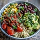 Colorful Plant-Based Taco Bowl, a hearty vegan meal topped with avocado and lime.