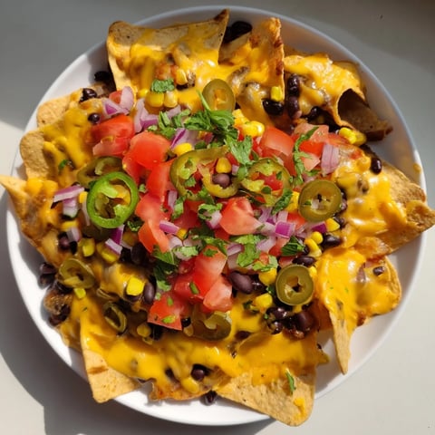 Warm, bubbly Sheet Pan Nachos laden with melted cheese, fresh toppings, served with cool salsa.