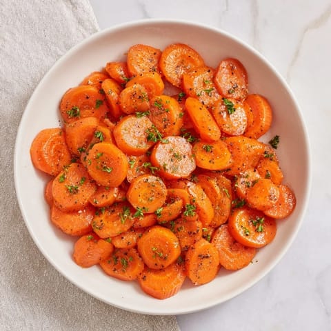 Golden honey-glazed carrots, glistening and tender, ready to be enjoyed with their vibrant glaze.