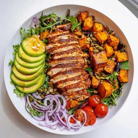Juicy grilled chicken and creamy avocado star in this flavorful Avocado and Sweet Potato Chicken Bowl recipe.