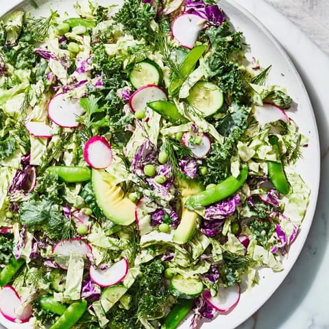 Fresh, colorful Green Goddess Detox Cabbage Salad with sliced cucumbers and avocado, ready to eat.