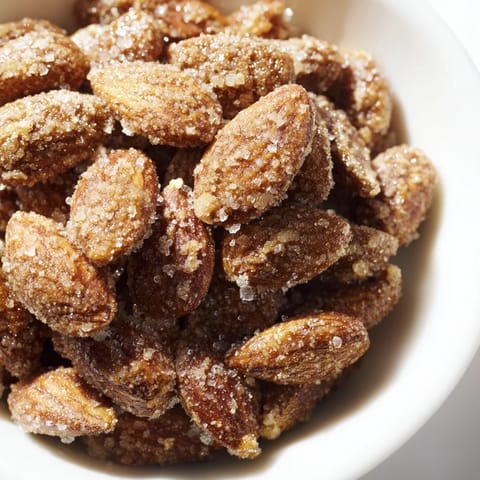 See the shiny, sugared surface of these warmly spiced cinnamon roasted almonds, ready for a perfect crunch.