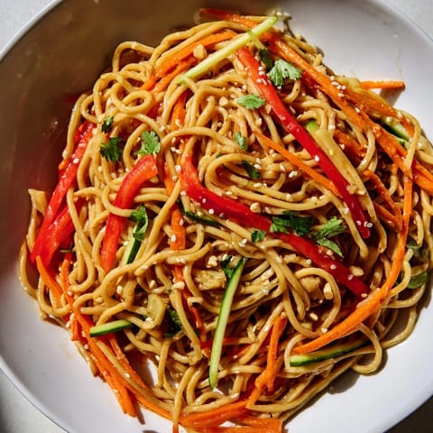 Close-up of fresh Garlic Noodle Salad, colorful julienned carrots and bell peppers shine beautifully.