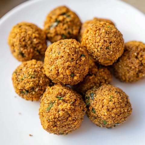 Freshly fried falafel, a Middle Eastern delight; these savory balls are seasoned perfectly with herbs and spices.