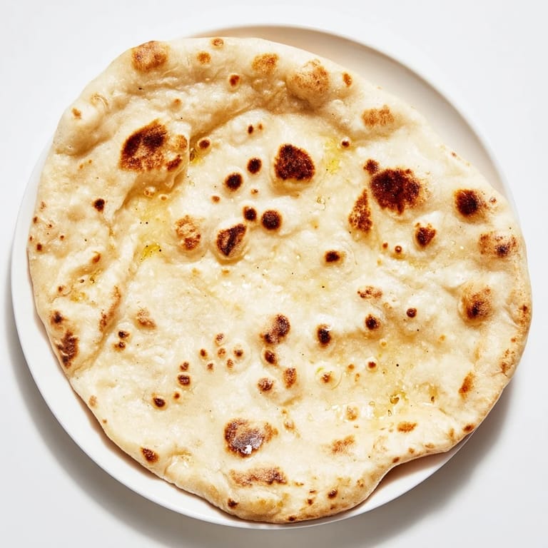 Homemade Three-Ingredient Easy Flatbreads, slightly puffed and speckled with brown from the hot skillet.