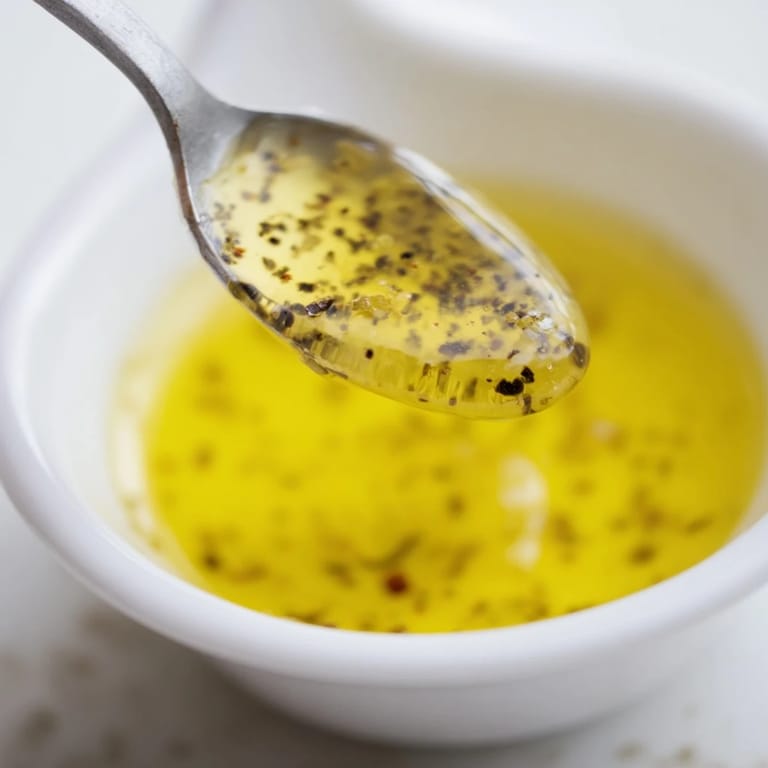 This Simple Honey Vinaigrette Salad Dressing is a bright, clear view of ingredients whisking together.