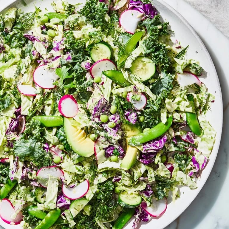Fresh, colorful Green Goddess Detox Cabbage Salad with sliced cucumbers and avocado, ready to eat.