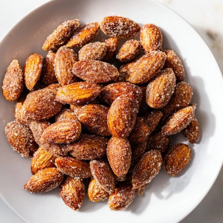 These toasty cinnamon roasted almonds are sprinkled with sugar, promising a sweet and satisfying bite for guests.