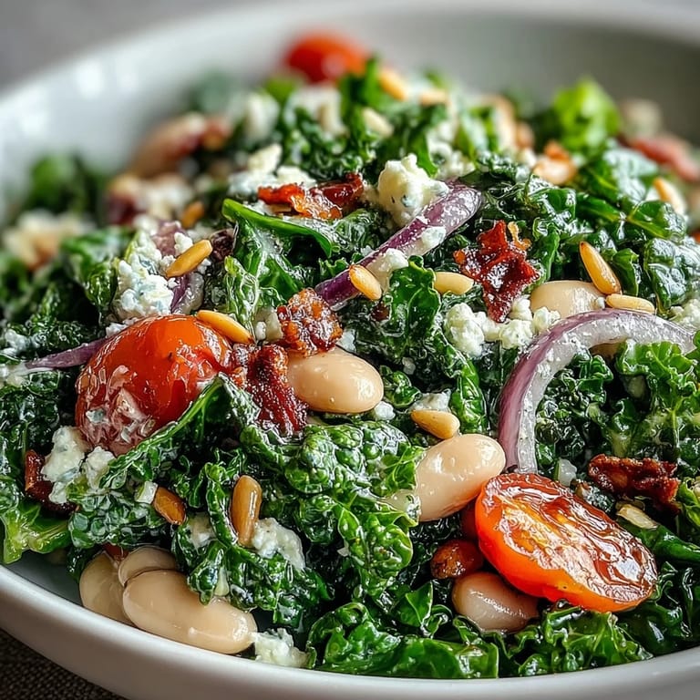 Creamy white bean and kale salad topped with vibrant cherry tomatoes.