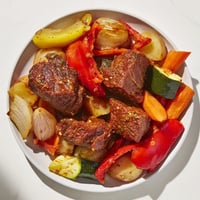 Juicy Jordanian Zarb features tender lamb and vibrant vegetables, slow cooked to smoky perfection, ready to serve.