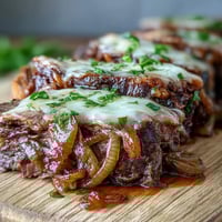 Savory Crock Pot French Onion Pot Roast with tender beef, caramelized onions, and melted Gruyere.